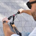 man testing scooter handlebar height