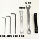 Minimal toolkit required for the Boardy scooter, showing six basic tools