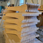 Stack of wooden Boardy decks in production, before coating which makes them more water resistant.