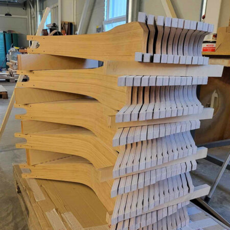 stack of wooden boardy decks in production, before coating which makes them more water resistant.