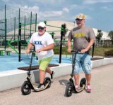 Made For Bigger Riders Too two men riding boardies on a sidewalk