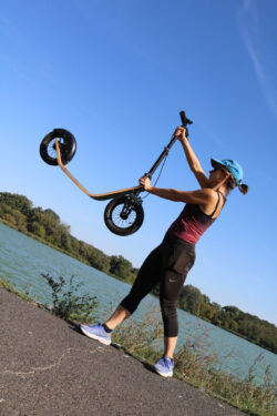 Lightweight, Carry-Friendly, Body-Friendly body friendly lightweight scooter. woman lifting a scooter overhead