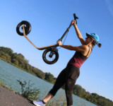 Lightweight, Carry-Friendly woman lifting scooter overhead