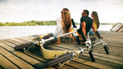 From Commute To Chill Mode a group of people sitting on a dock with boardies