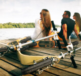 From Commute To Chill Mode a group of people sitting on a dock with boardies