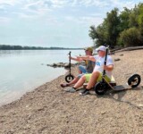Scooter. Chill. Repeat. relaxing by the riverside with their boardy scooters beside them.