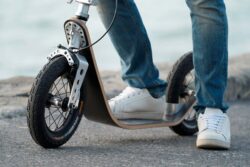 Low Deck close-up of a rider’s foot on a boardy scooter, showing the low deck design.