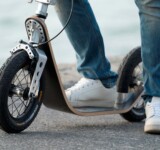 Low Deck close-up of a rider’s foot on a boardy scooter, showing the low deck design.