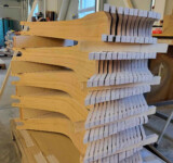 Deck Stack Waiting For Coating Which Makes Them More Water Resistant. stack of wooden boardy decks in production, before coating which makes them more water resistant.