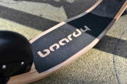 Logo Close-Up close-up of the boardy deck logo with deck curve on a walkway.